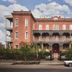Hotel Saint Vincent in New Orleans, red-brick historic hotel facade with balconies and street view