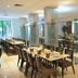 Luxor Soft Hotel Teresina restaurant with long set dining tables and glass partitions in Teresina
