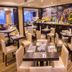 Del Pilar Miraflores Hotel Lima restaurant with set tables, beige chairs and city views