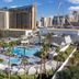 Horseshoe Las Vegas pool deck with palm trees, cabanas, and city skyline view in Las Vegas