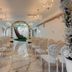 Thunderbird Boutique Hotel in Las Vegas wedding chapel with white chairs, floral arch, and chandeliers