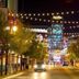 Thunderbird Boutique Hotel in Las Vegas on a neon-lit street with string lights and casino signs at night