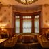 The Hotel Chelsea in New York lounge with bay window seating, chandeliers, and vintage decor