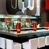 Ameritania at Times Square bar with white stools and mirrored liquor shelves in New York