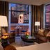The Bostonian Boston room with floor-to-ceiling city views and a balcony overlooking Boston skyline