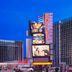 Horseshoe Las Vegas exterior on the Las Vegas Strip with tall hotel towers and bright digital signs