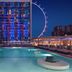The LINQ Hotel & Casino Las Vegas rooftop pool at night with the High Roller in the background