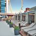 The LINQ Hotel & Casino in Las Vegas rooftop lounge with loungers and a view of the High Roller