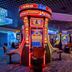 The LINQ Hotel & Casino in Las Vegas gaming floor with colorful slot machines and carpeted seating area