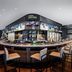 Caesars Sportsbook lounge inside The LINQ Hotel & Casino in Las Vegas with a circular bar and stools