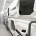Hostel Space Capsule in Madrid: sleek capsule pods line a narrow, modern hostel hallway