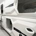 Hostel Space Capsule in Madrid with white capsule-style bunk beds in a narrow shared dorm