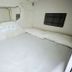 Hostel Space Capsule in Madrid: compact capsule room with white bed, wall mirror, and padded headboard.